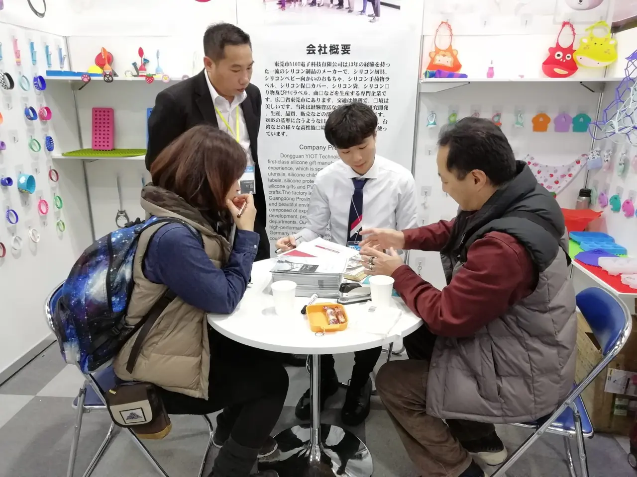 Visitors and team members discussing products at an exhibition booth