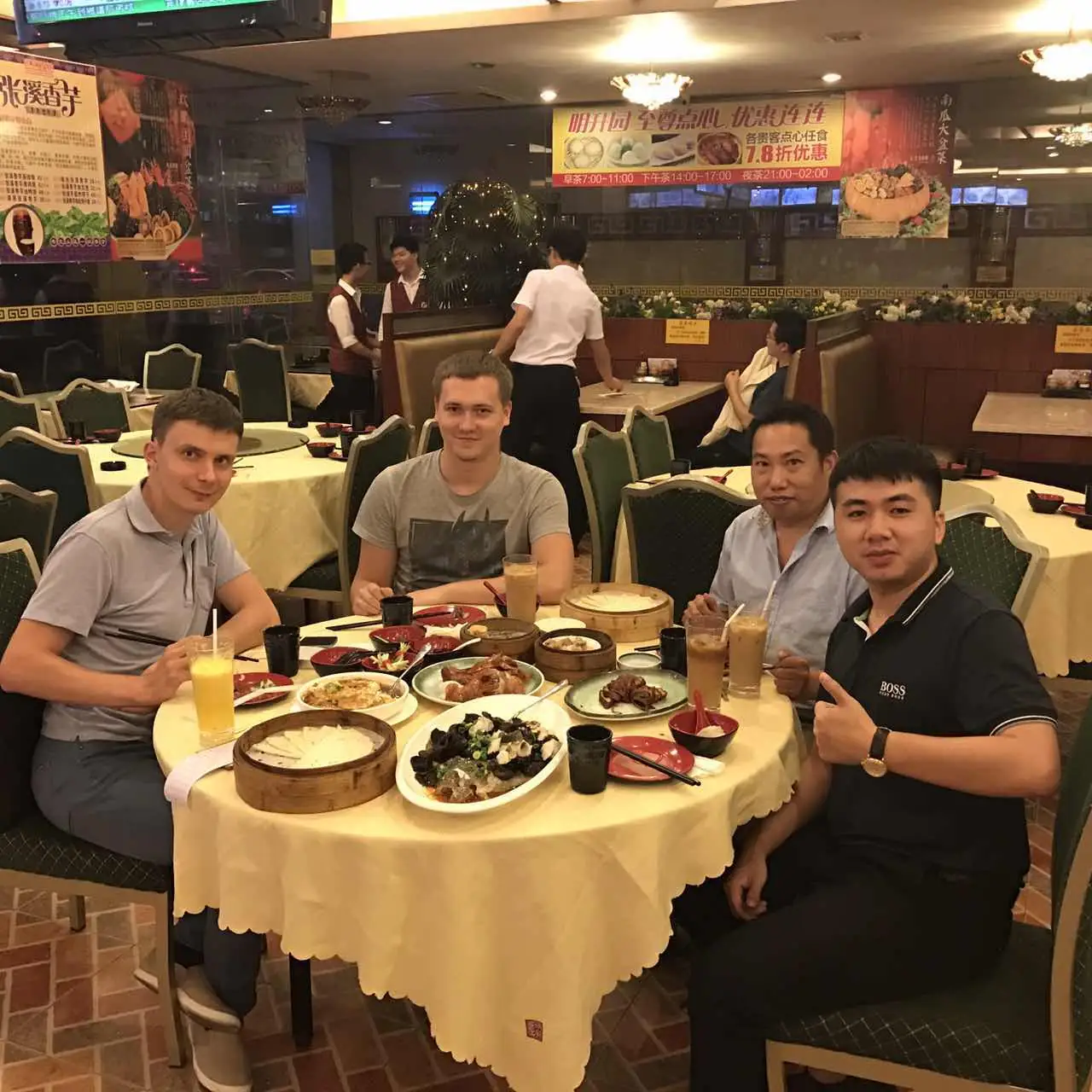 Business visitors and team members gathered around a dinner table