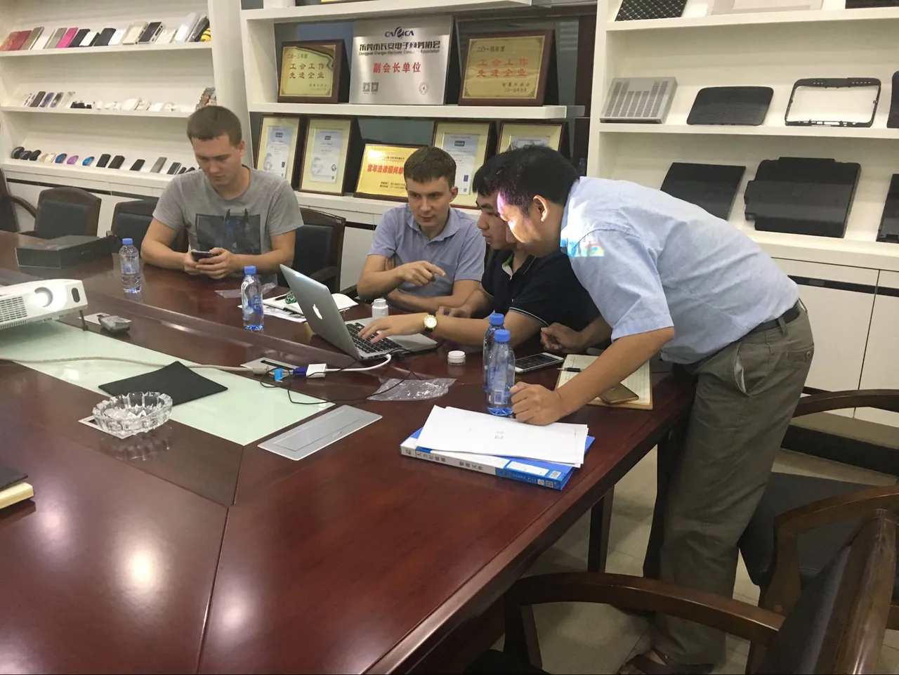 Project discussion with visitors around a meeting table